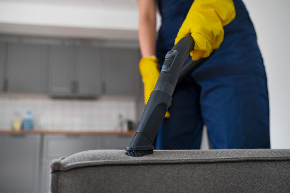 Vacuuming a piece of furniture in a residence